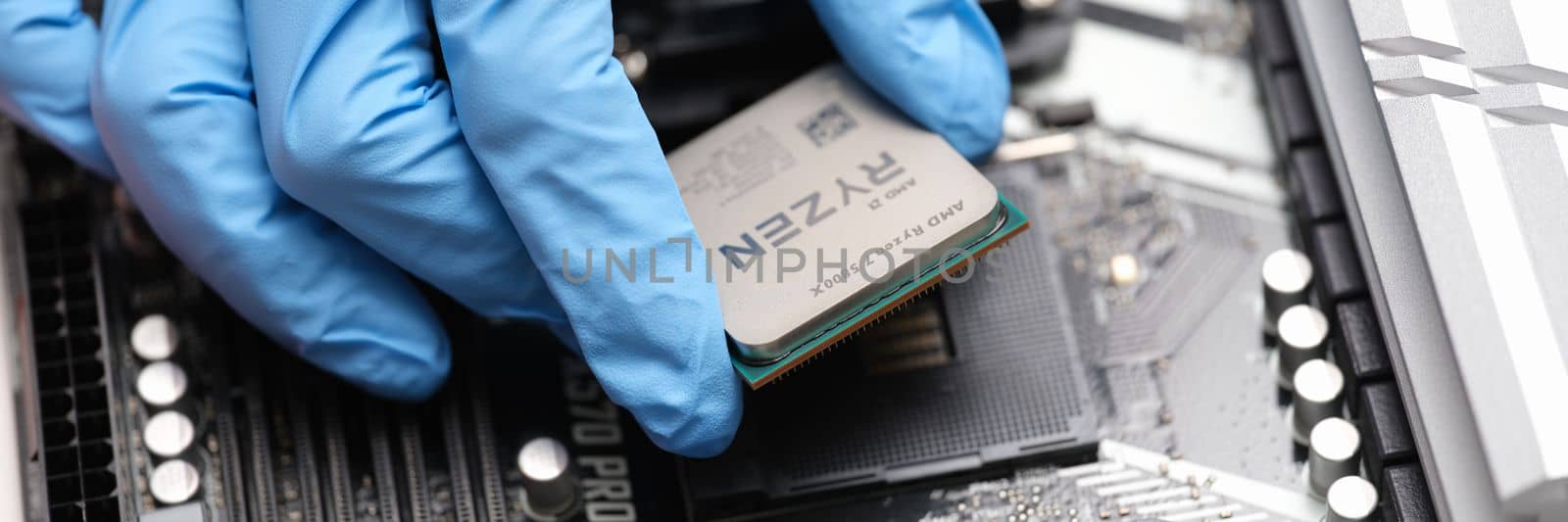 Tbilisi, Georgia - July 26, 2022: Installation of third generation Ryzen processor on motherboard by kuprevich