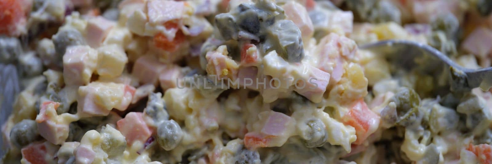 Traditional Russian Olivier salad of boiled sausage pickled green peas, eggs and mayonnaise by kuprevich