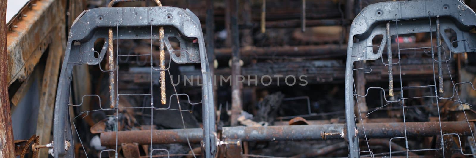 Burnt rusty car after fire or accident. Abandoned old burnt car concept