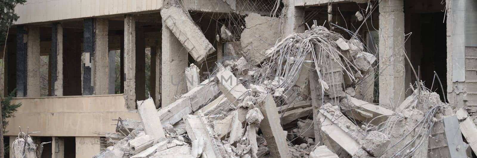Destroyed cement building warrior rocket strike or earthquake by kuprevich