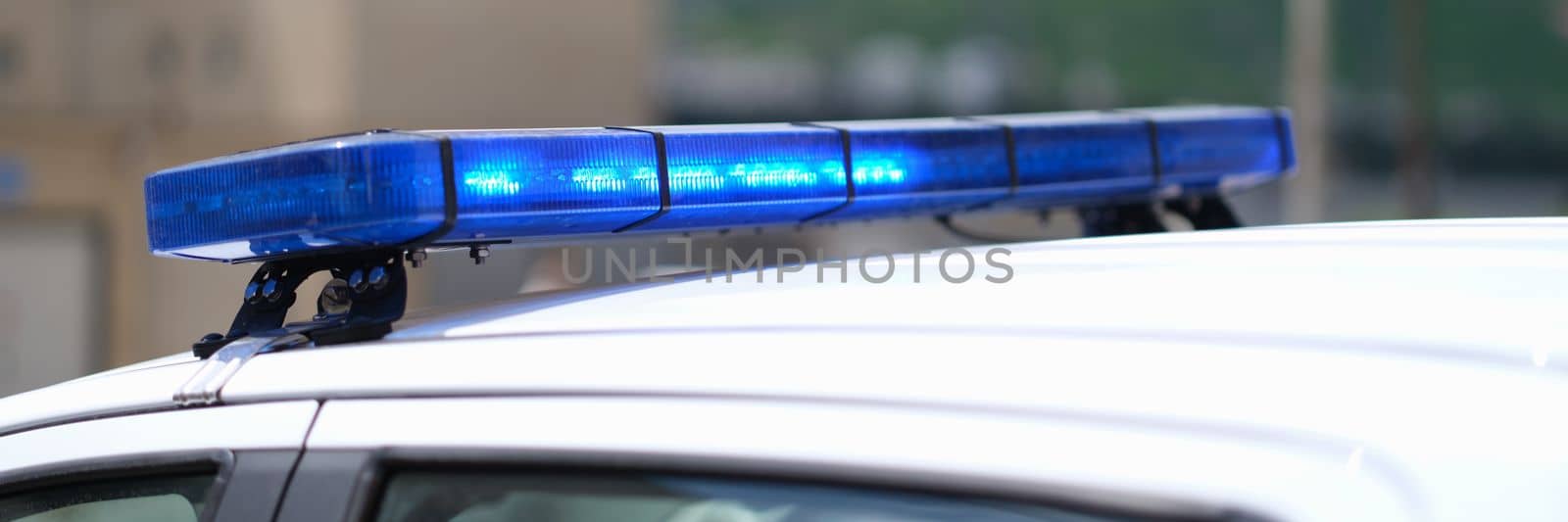 Closeup of blue lights on roof of police car by kuprevich