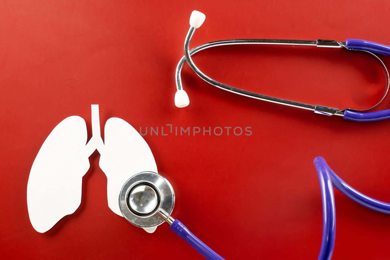 World Tuberculosis Day. Top view of lungs paper symbol and medical stethoscope on red background, copy space, lung cancer awareness, concept of world TB day, Healthcare and medicine concept