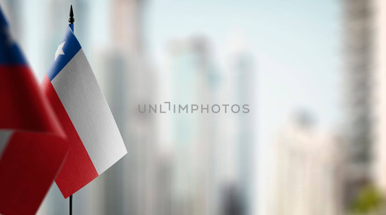 Small flags of the Chile on an abstract blurry background by butenkow