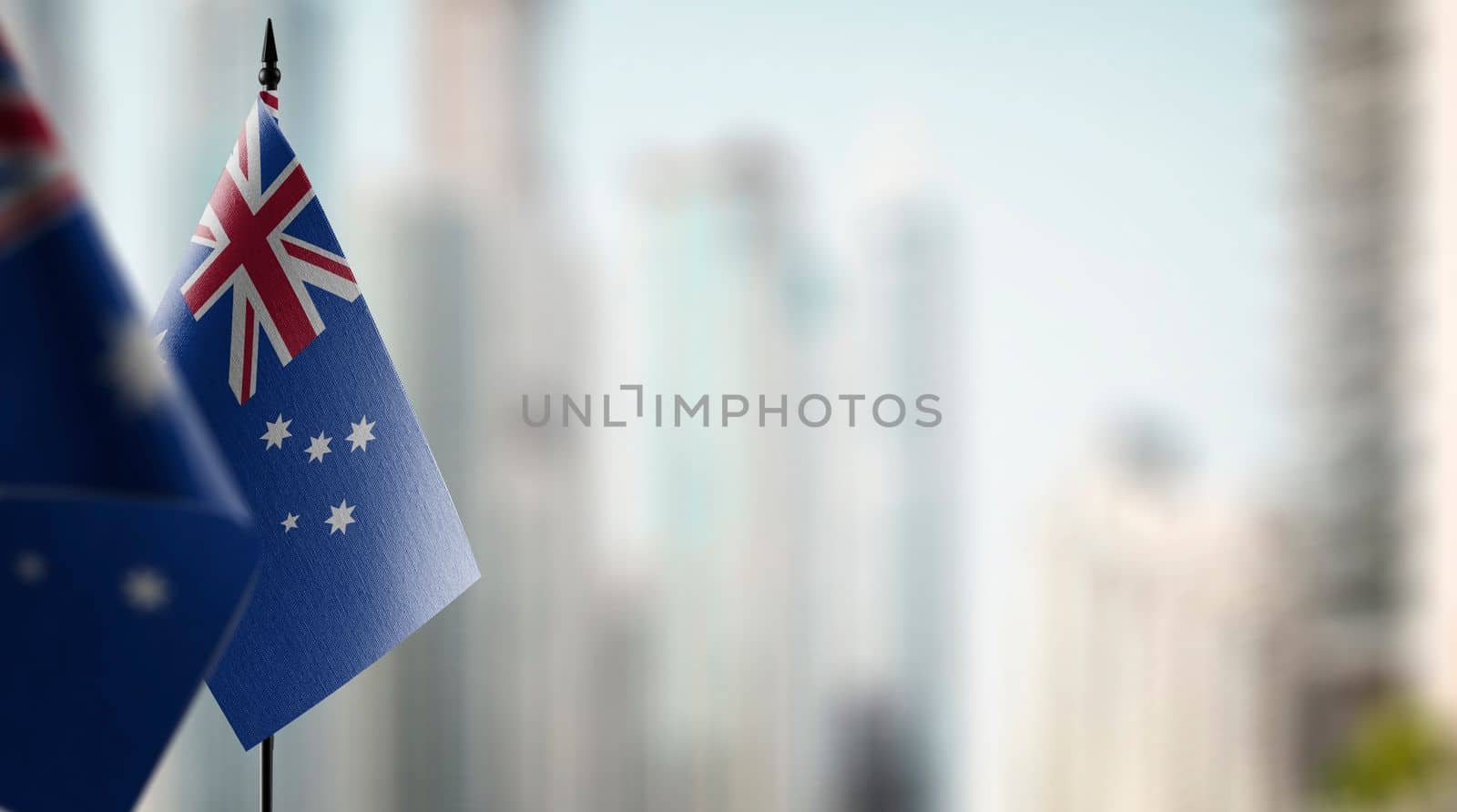 Small flags of the Australia on an abstract blurry background.