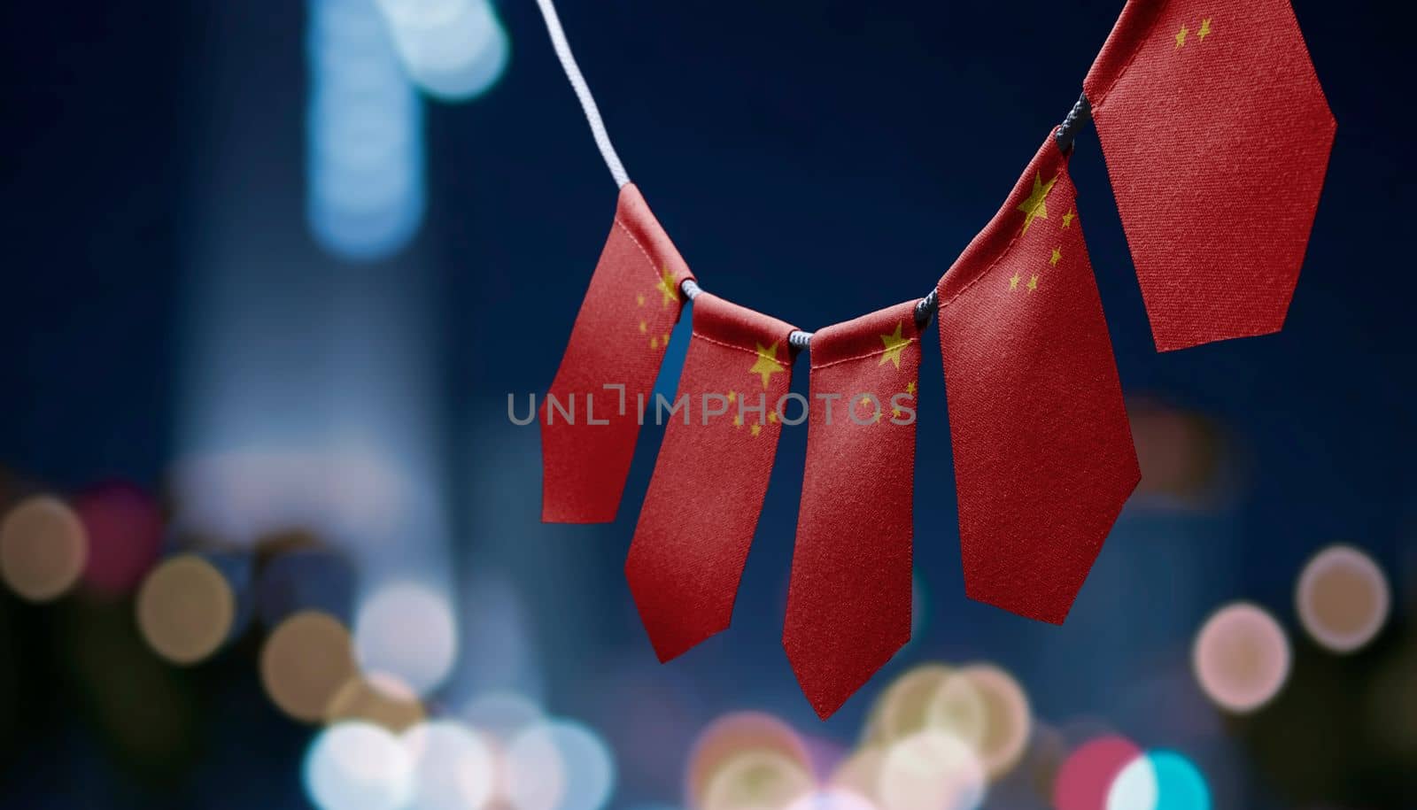 A garland of China national flags on an abstract blurred background.