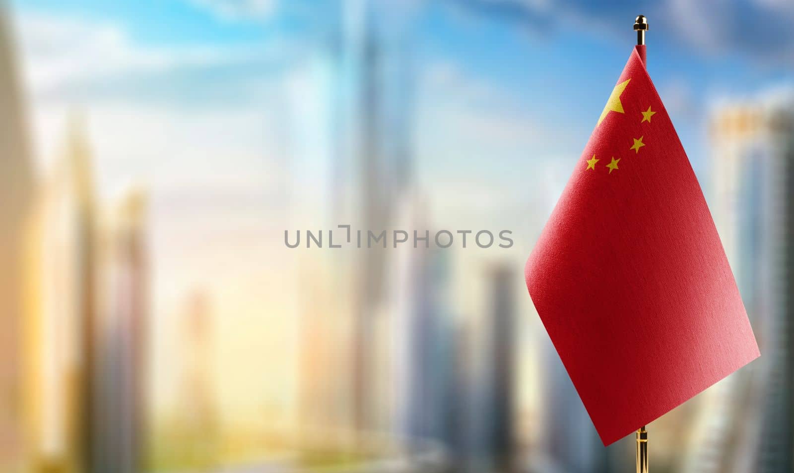 Small flags of the China on an abstract blurry background.