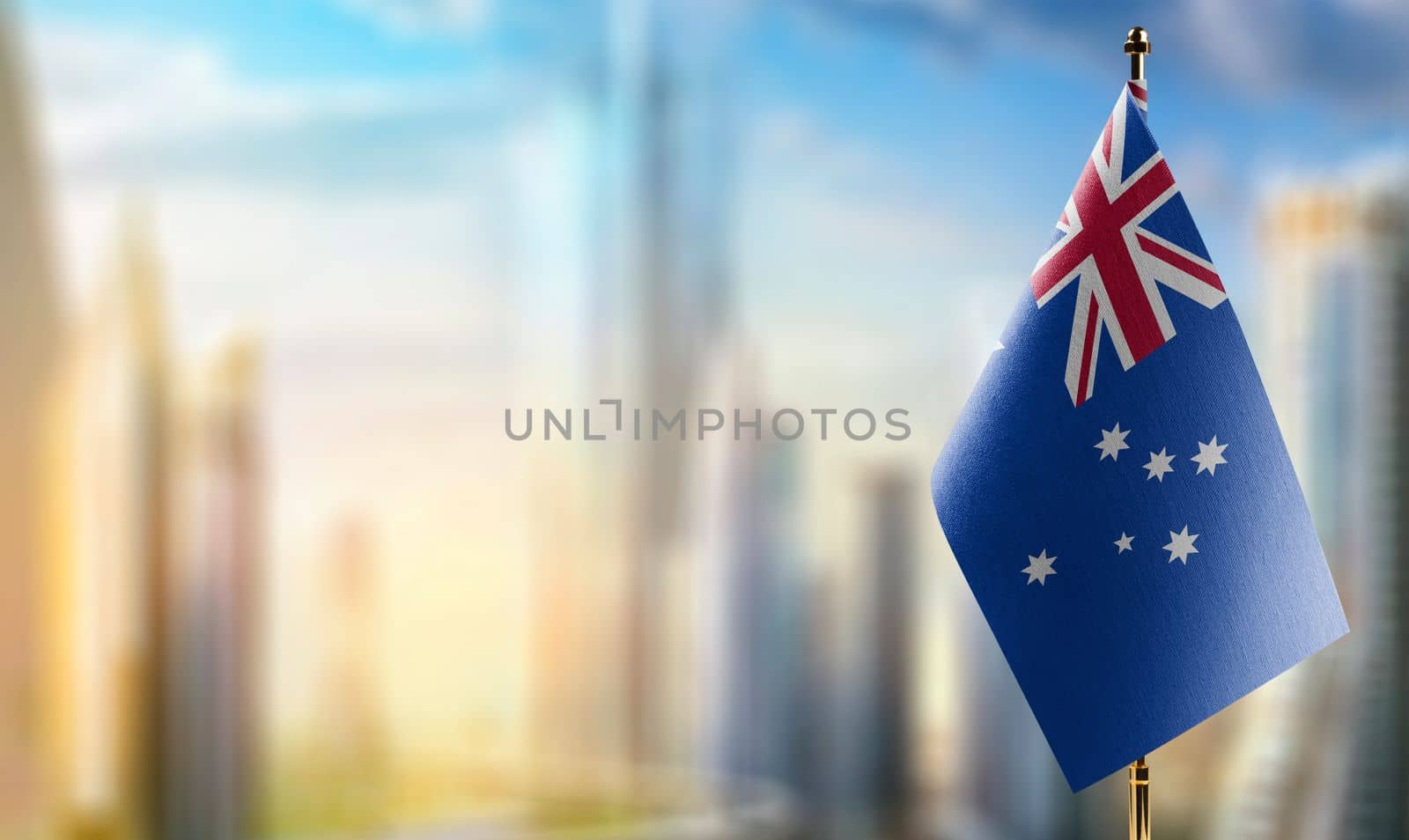 Small flags of the Australia on an abstract blurry background.