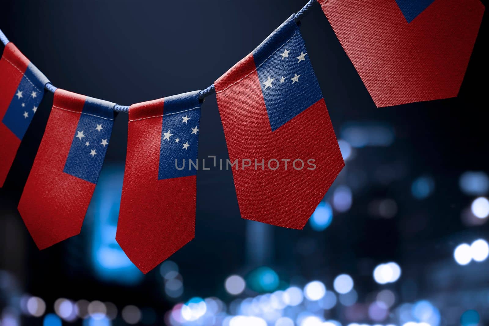 A garland of Samoa national flags on an abstract blurred background.