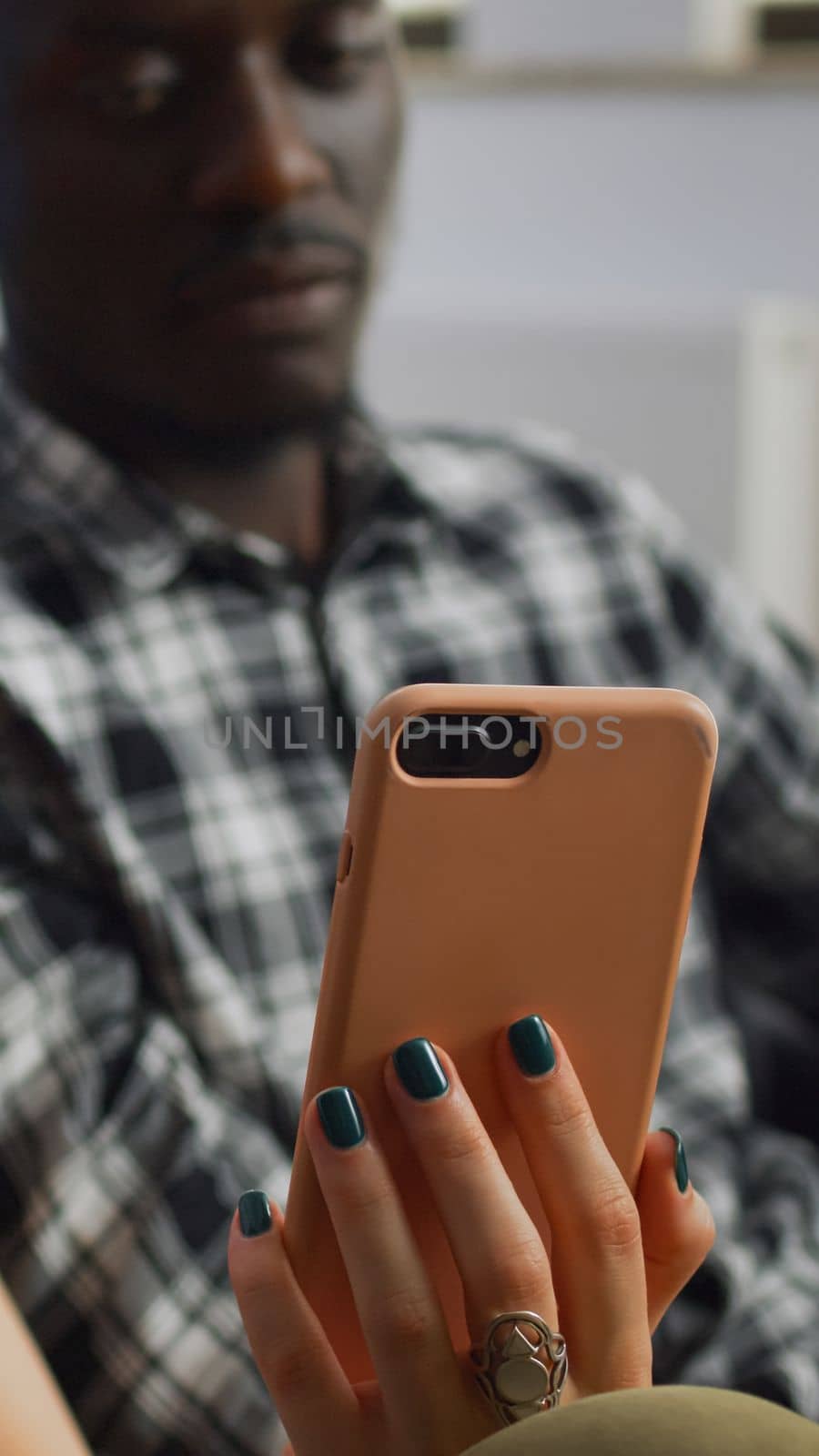 Close up of interracial couple looking at smartphone by DCStudio