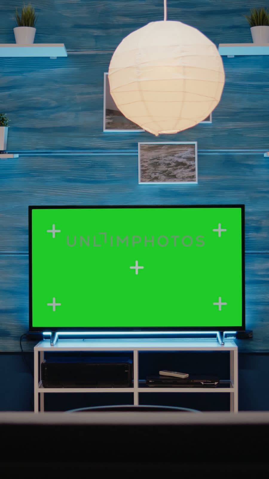 Green screen design on television in empty room at modern flat. Chroma key digital concept on monitor display used for blank mockup template, isolated media background for copy space