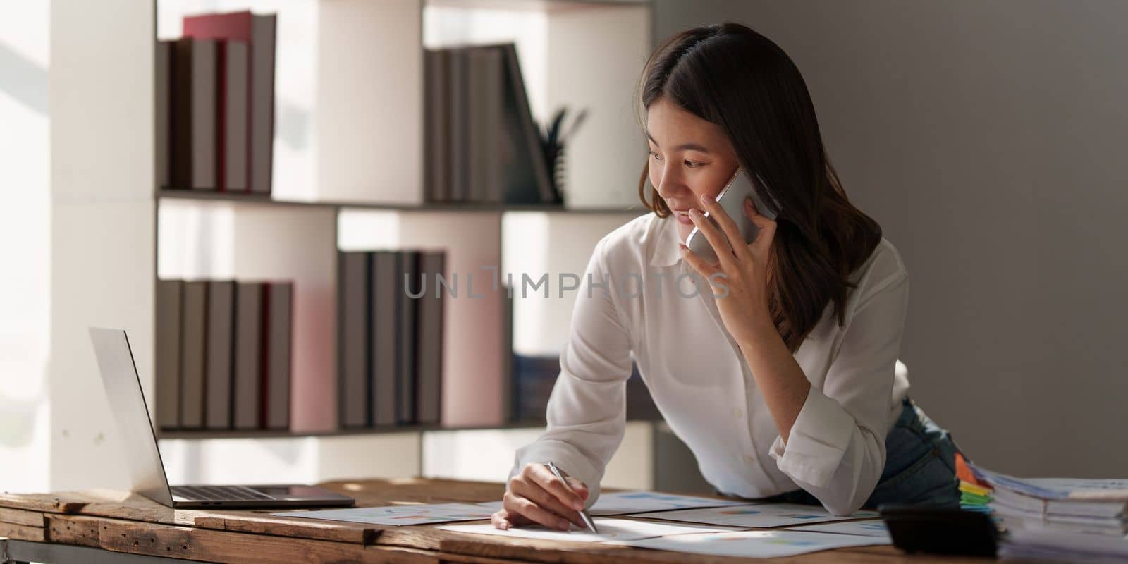 Beautiful business woman talking on the mobile phone. Management, planning and networking phone call concept by itchaznong