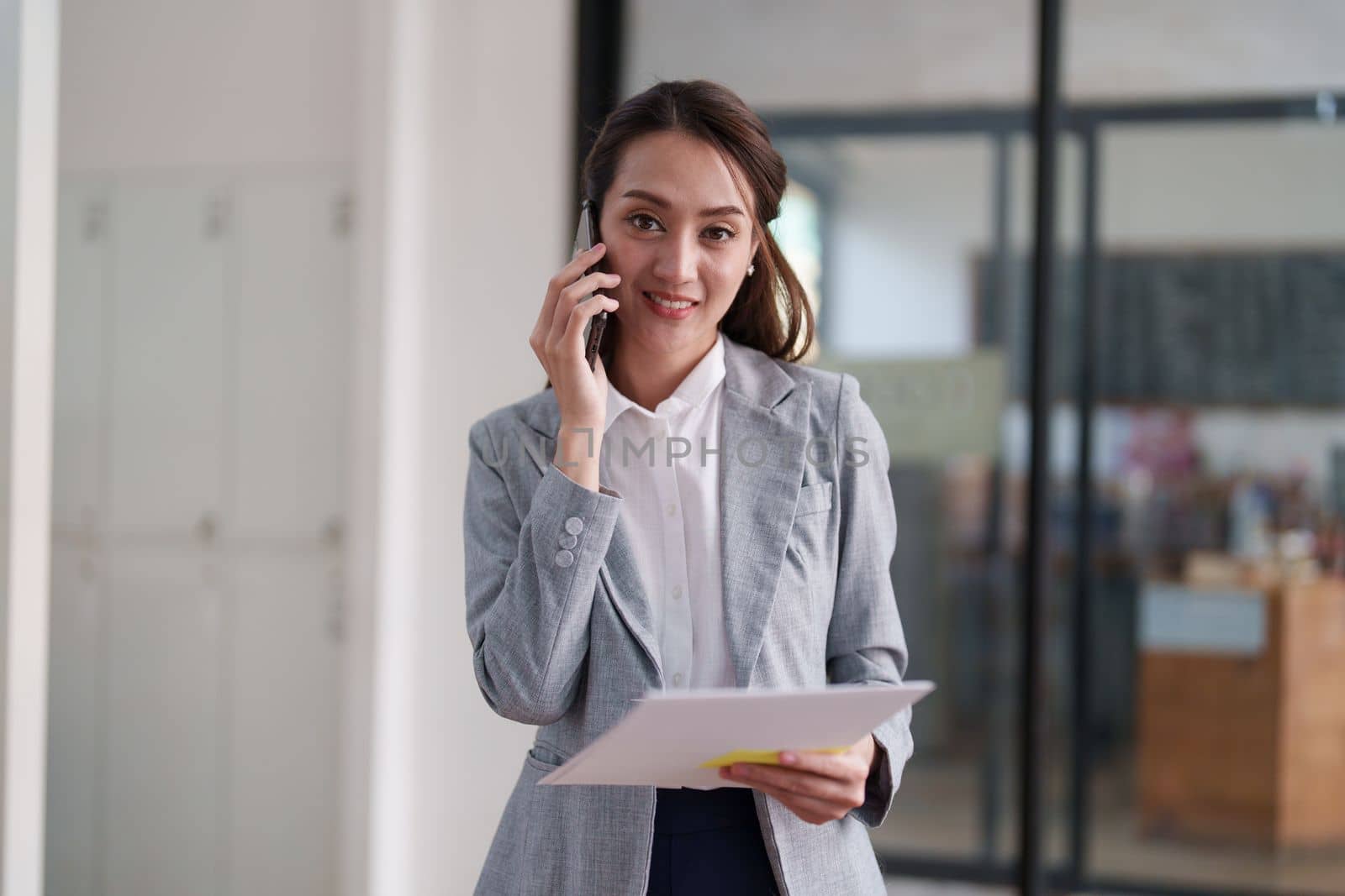 Beautiful business woman talking on the mobile phone. Management, planning and networking phone call concept