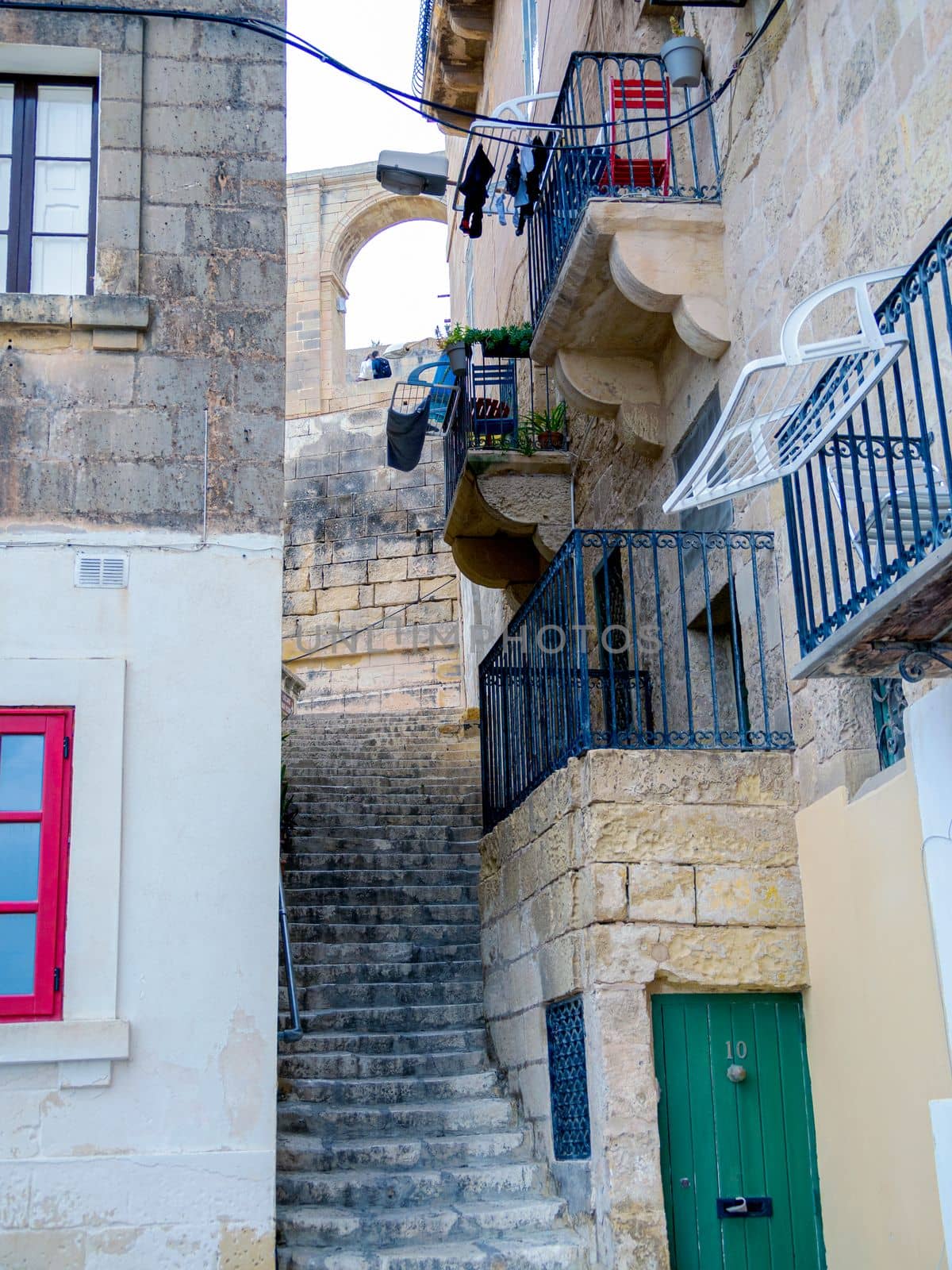 Fragment of the building's facade with traditional wooden ornate balconies painted in Valletta, Malta. High quality photo