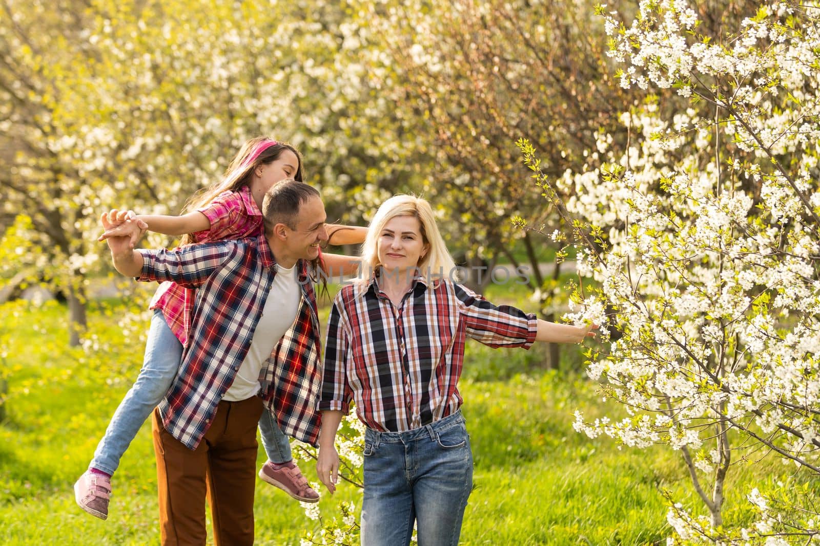 Young family with child having fun in nature.