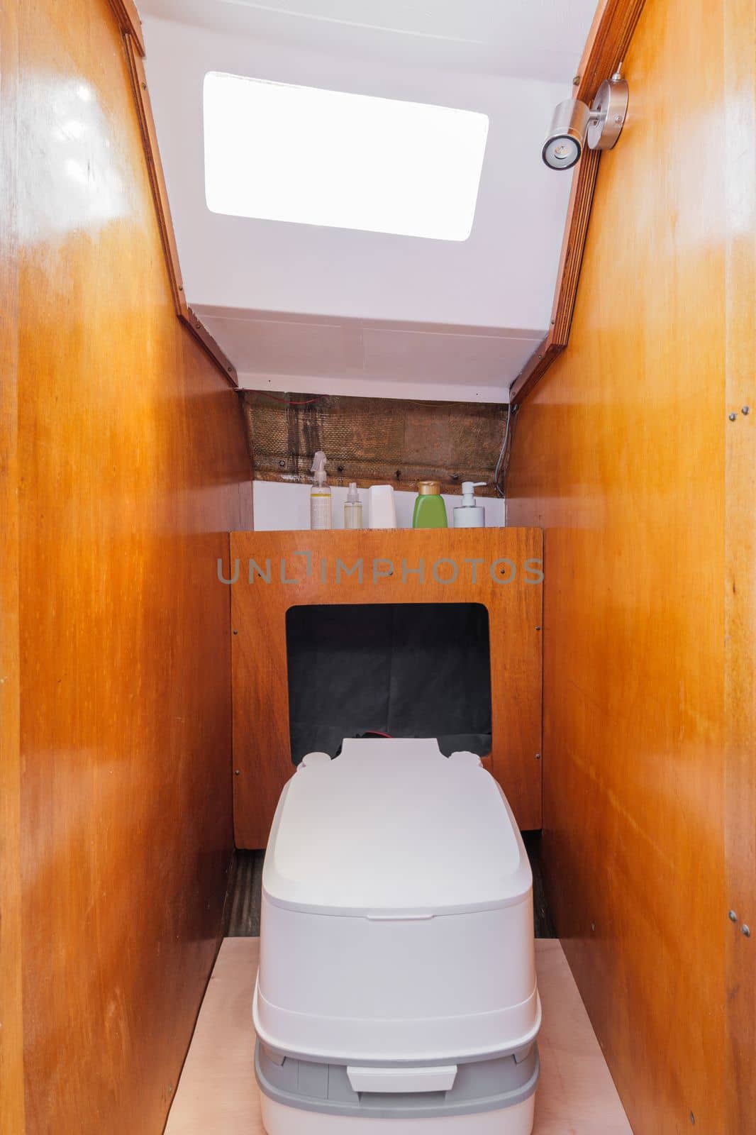 Cozy bathroom in small yacht with wooden walls. Compact stylish modern thoughtful yacht. Concept of comfortable conditions while traveling..