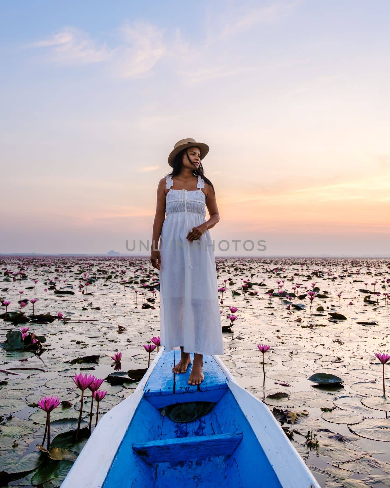 Asian women in a boat at the Red Lotus Sea in Udon Thani Thailand. by fokkebok