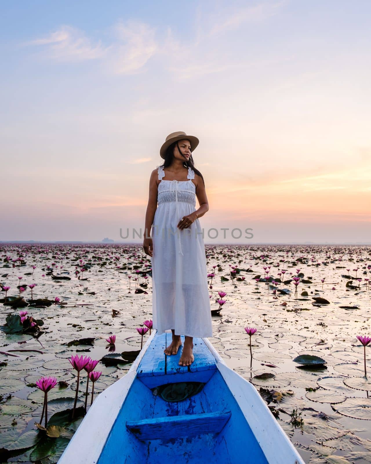 Asian women in a boat at the Beautiful Red Lotus Sea in Udon Thani in northern Thailand. Flora of Southeast Asia.