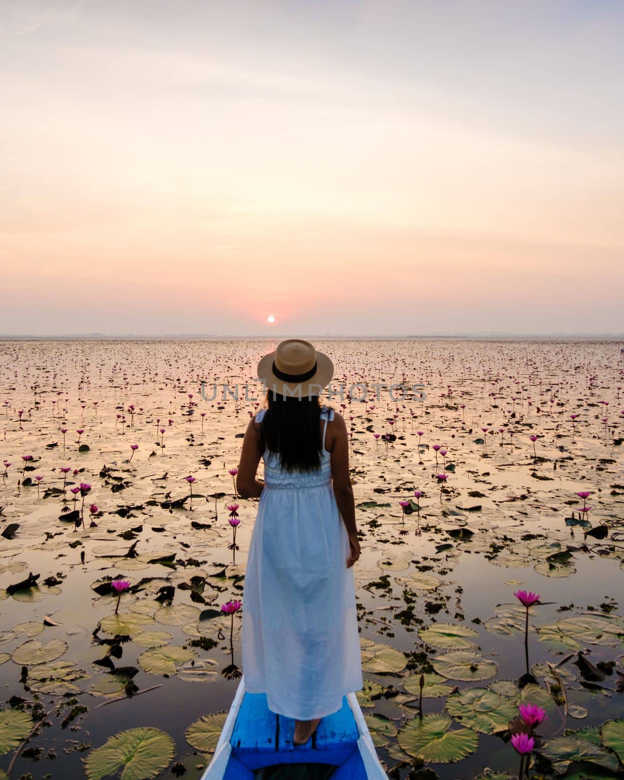 Asian women in a boat at the Red Lotus Sea in Udon Thani Thailand. by fokkebok