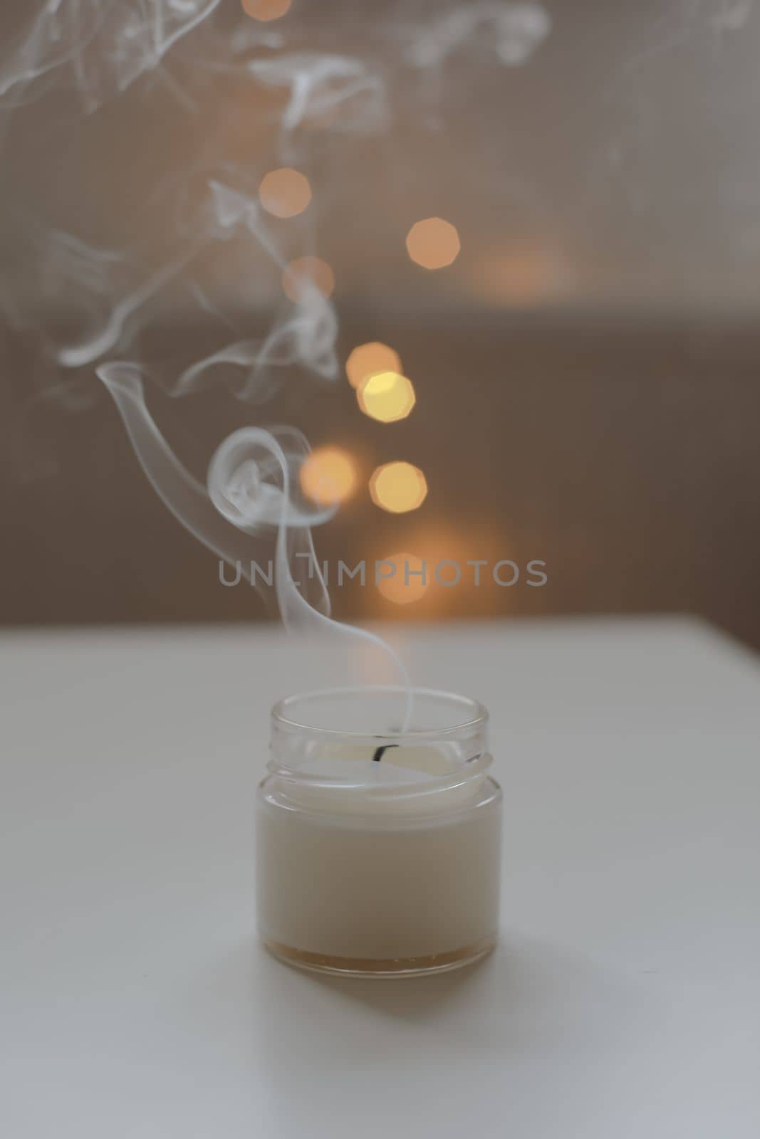 Cozy home composition with candle on a blurred background.