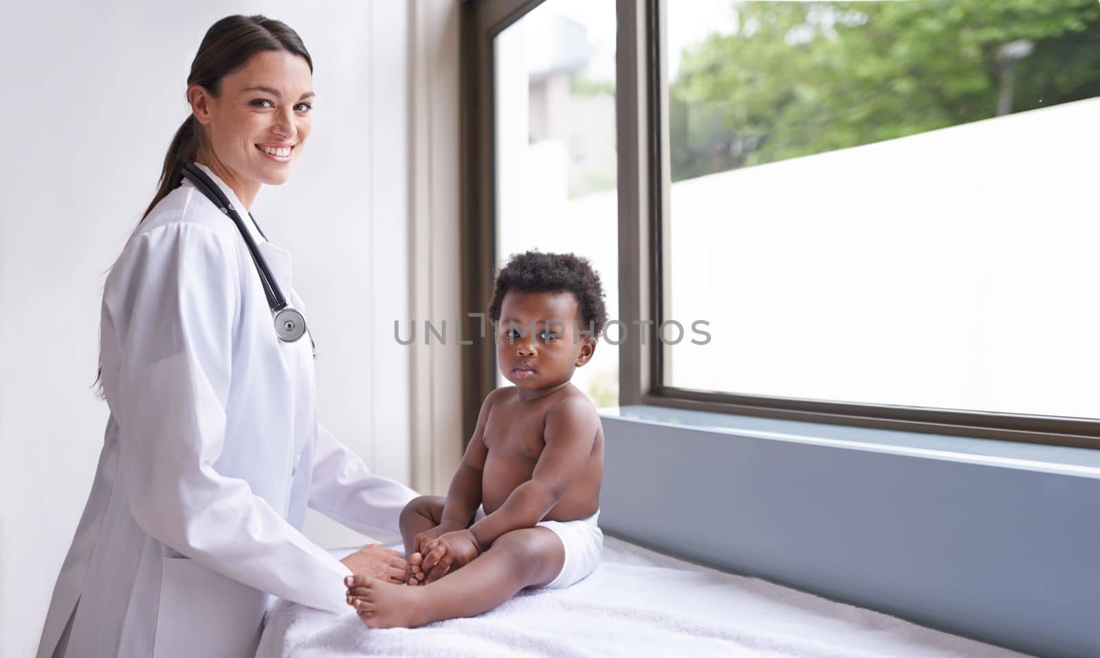 Just in for a routine pediatric checkup. a female pediatrician doing a checkup on an adorable baby boy