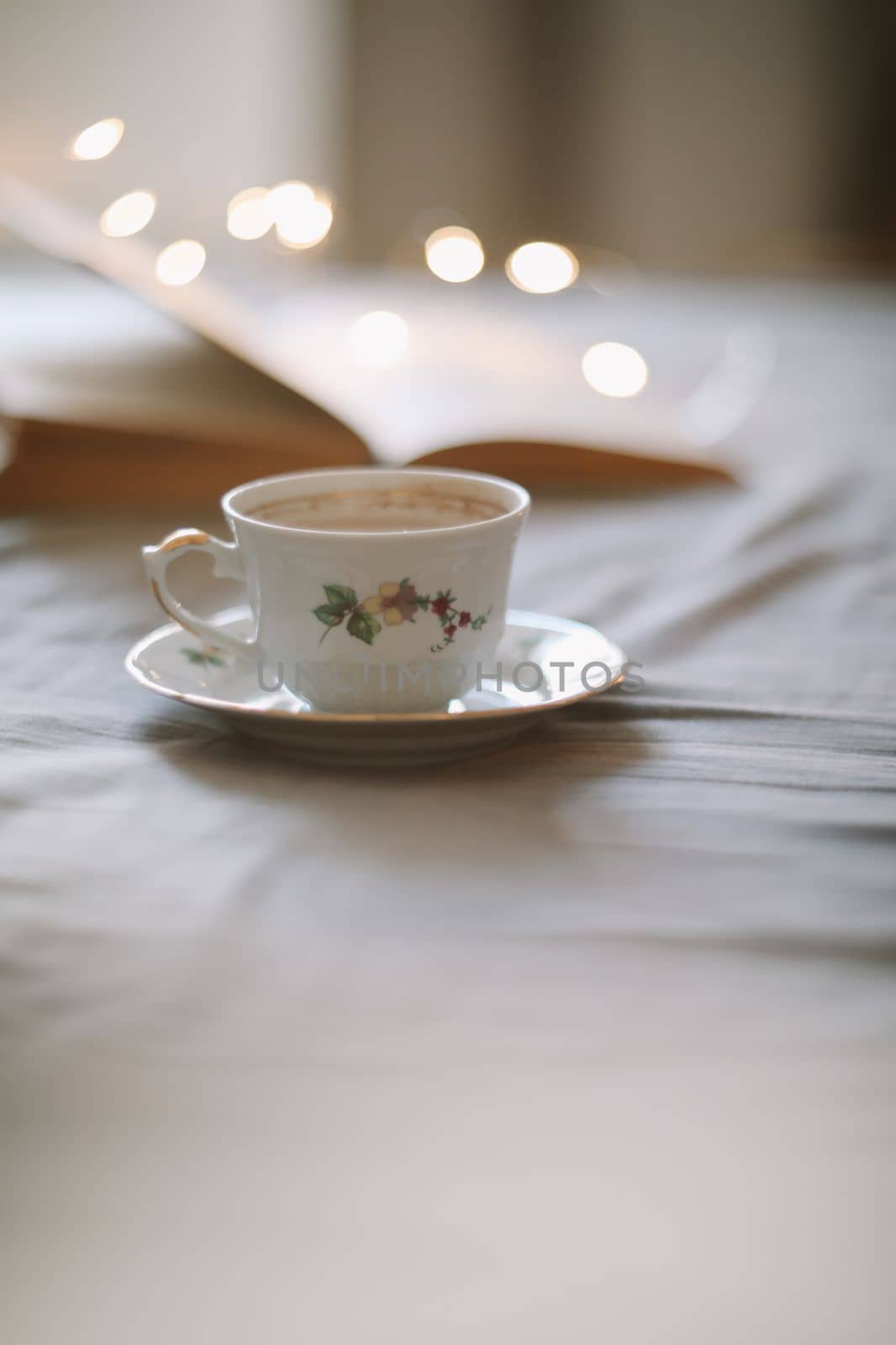 Spring still life. Breakfast in bed. White bedroom. Sweet home. Book and coffee cup