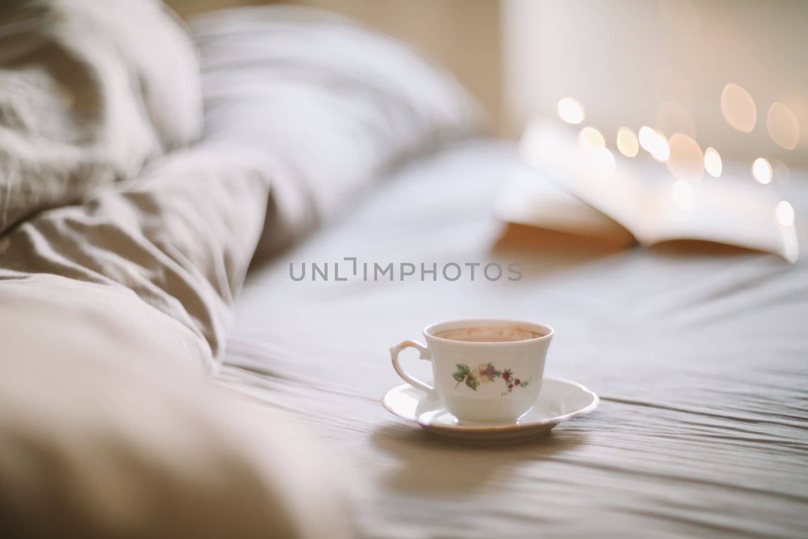 Spring still life. Breakfast in bed. White bedroom. Sweet home. Book and coffee cup