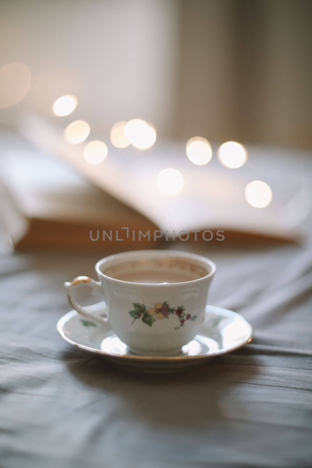 Spring still life. Breakfast in bed. White bedroom. Sweet home. Book and coffee cup