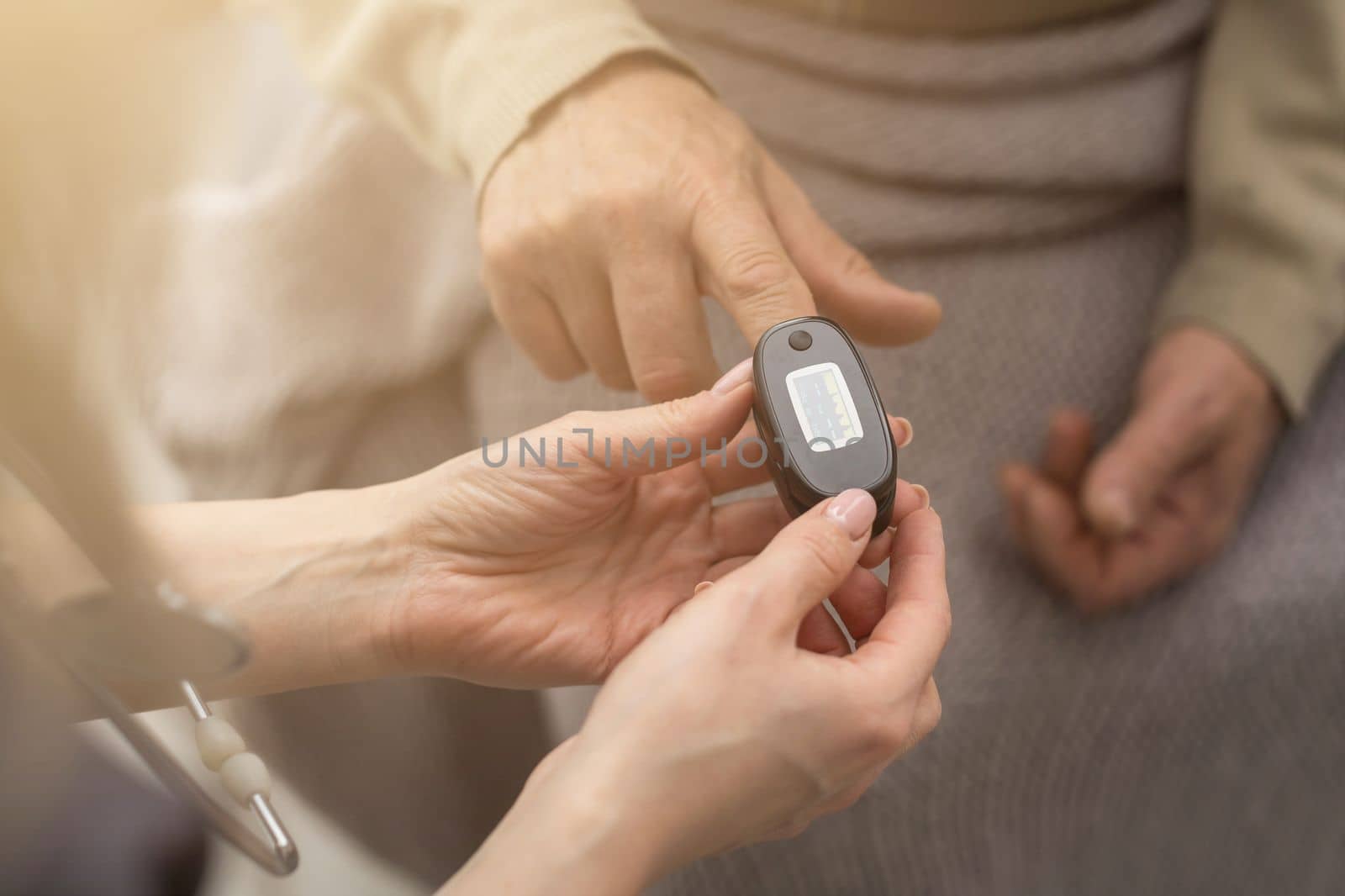 elderly man and nurse measuring pulse oximeter by Andelov13