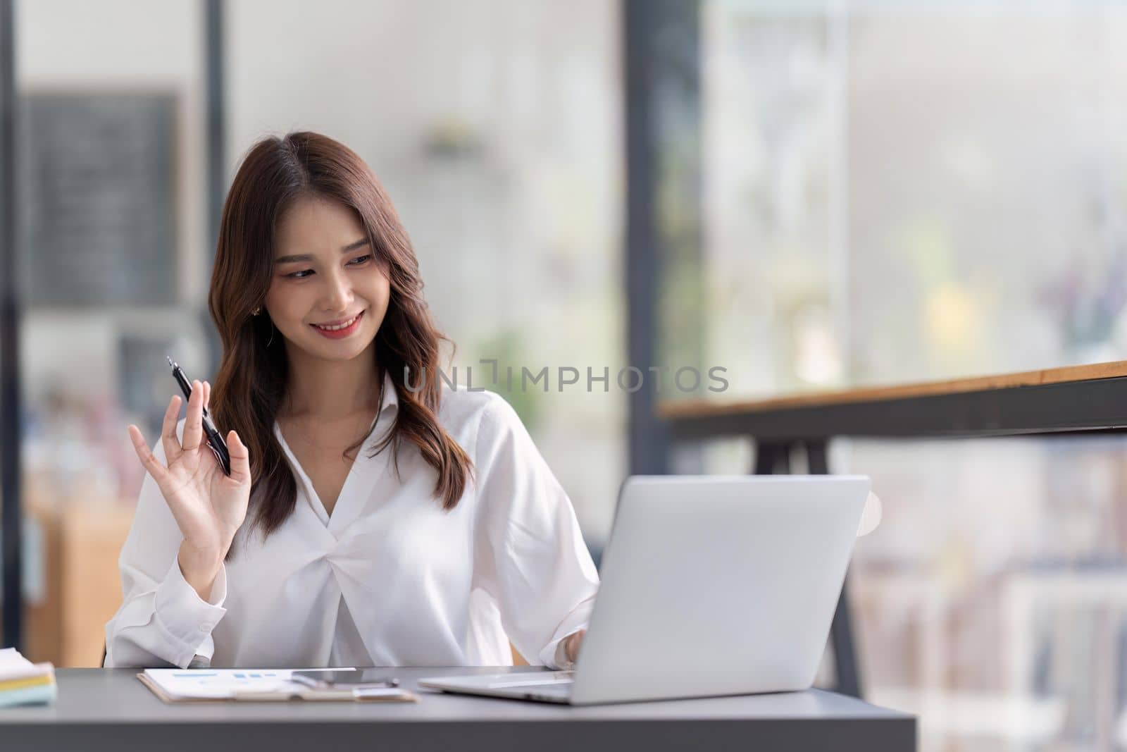 Business woman working on laptop and working at office desk at office.