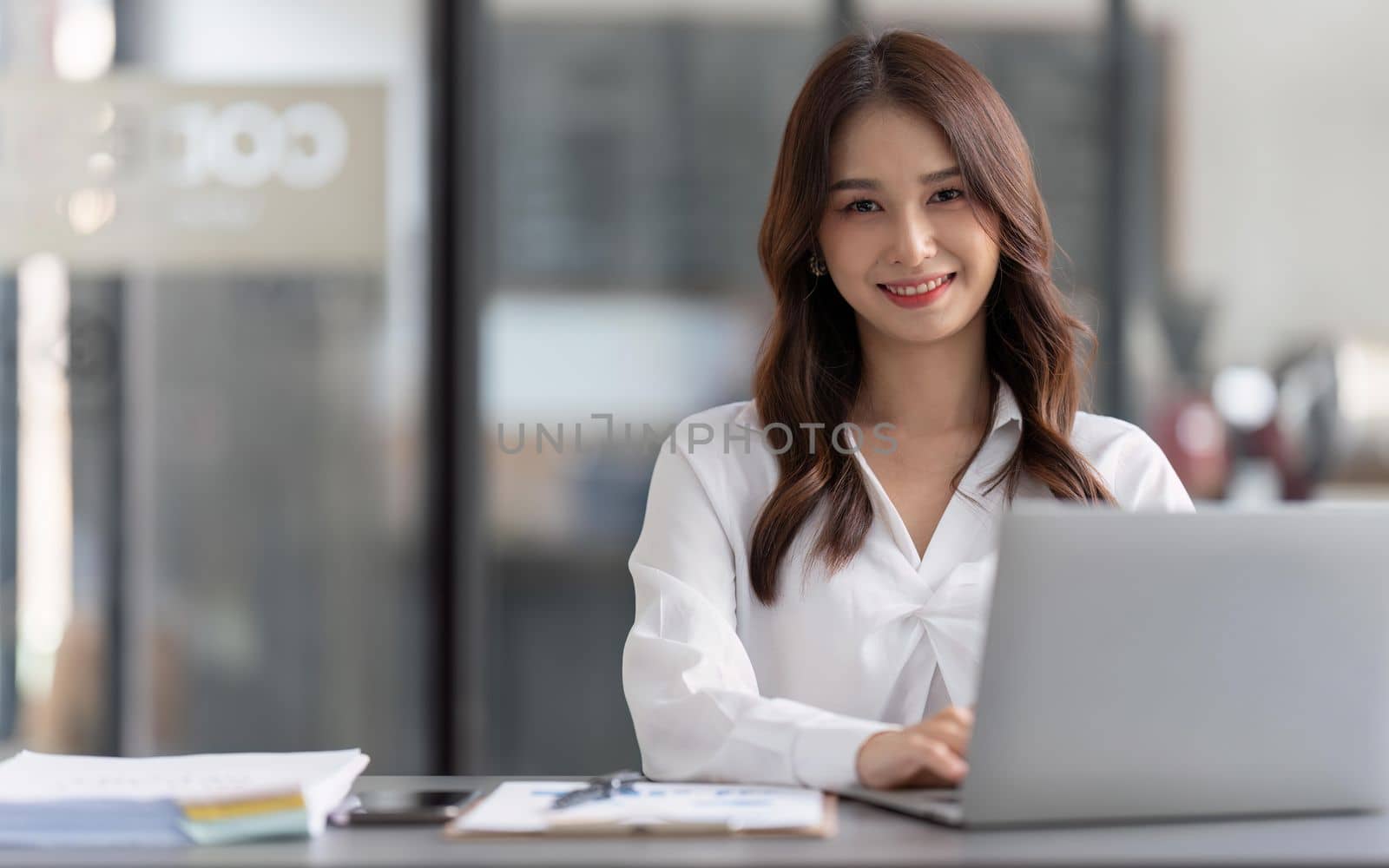 Business woman working on laptop and working at office desk at office by nateemee