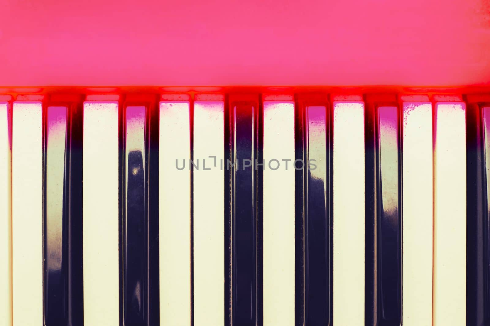 a set of keys on a piano or similar musical instrument. White and black musical keys of piano synthesizer with space for text.
