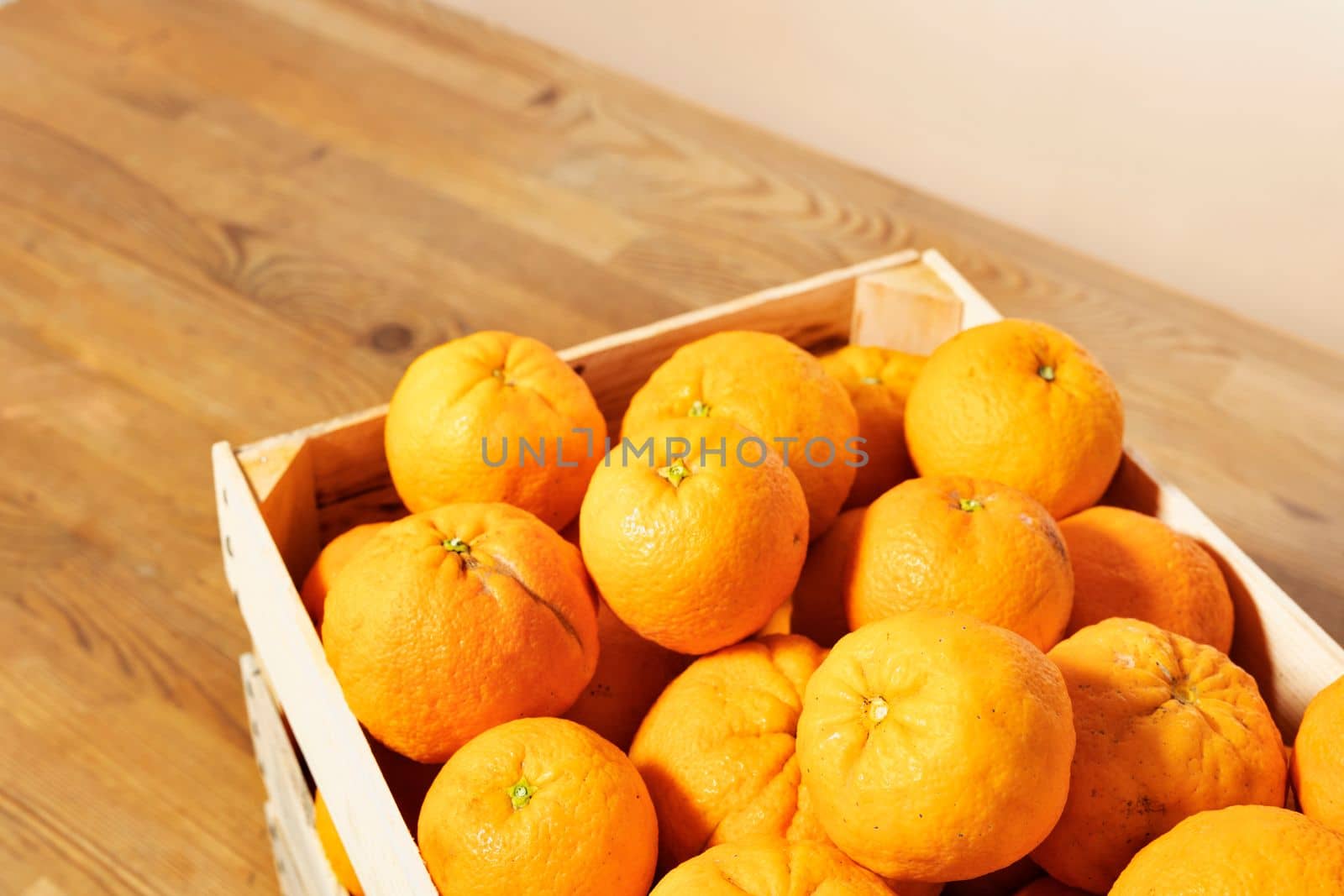 Fresh oranges in wooden box by victimewalker