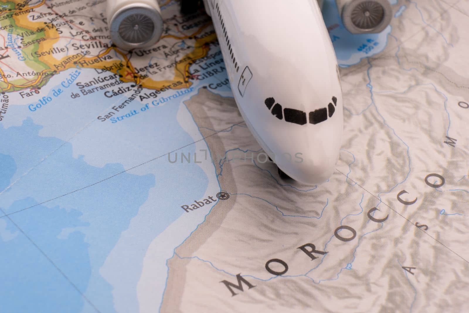 Passenger plane on a map highlighting Rabat, Morocco through selective focus, background blur. High quality photo