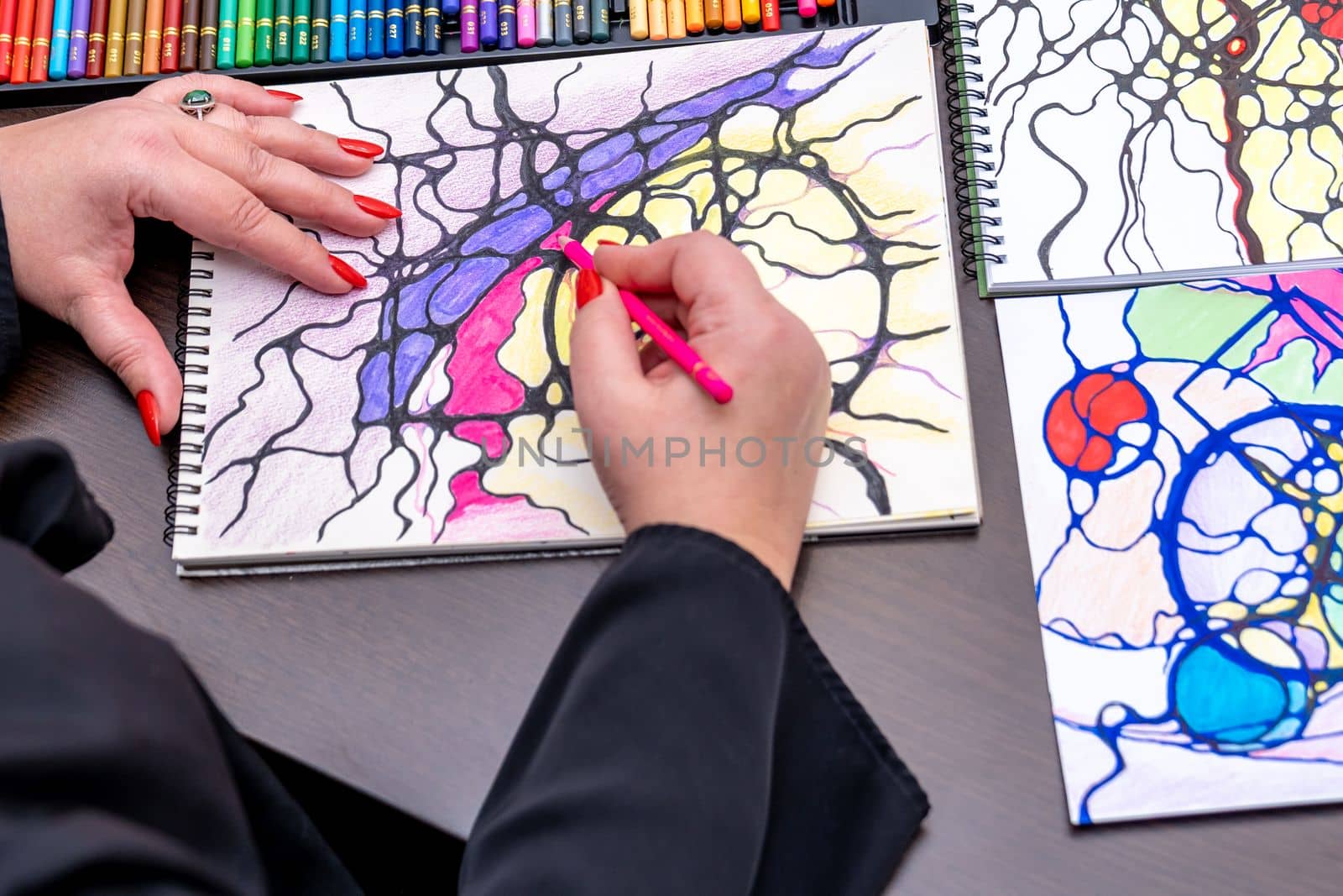 drawing neurographics with colored pencils on paper. High quality photo