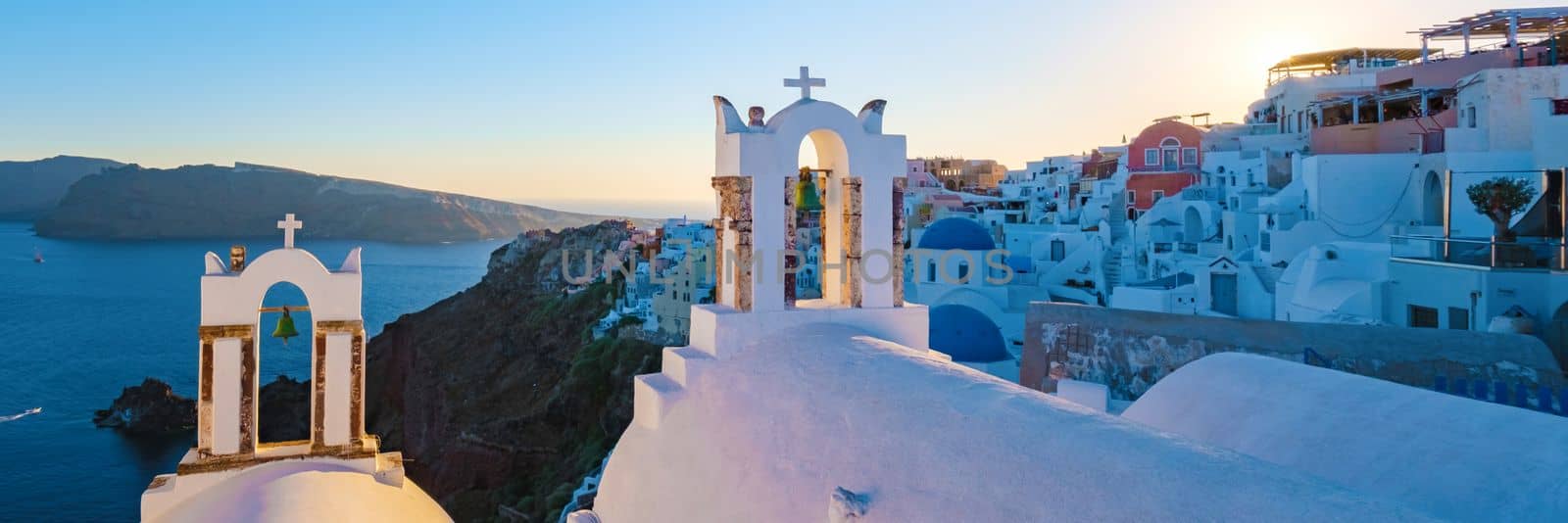 Oia Santorini Greece in the evening during sunset, traditional Greek village  by fokkebok