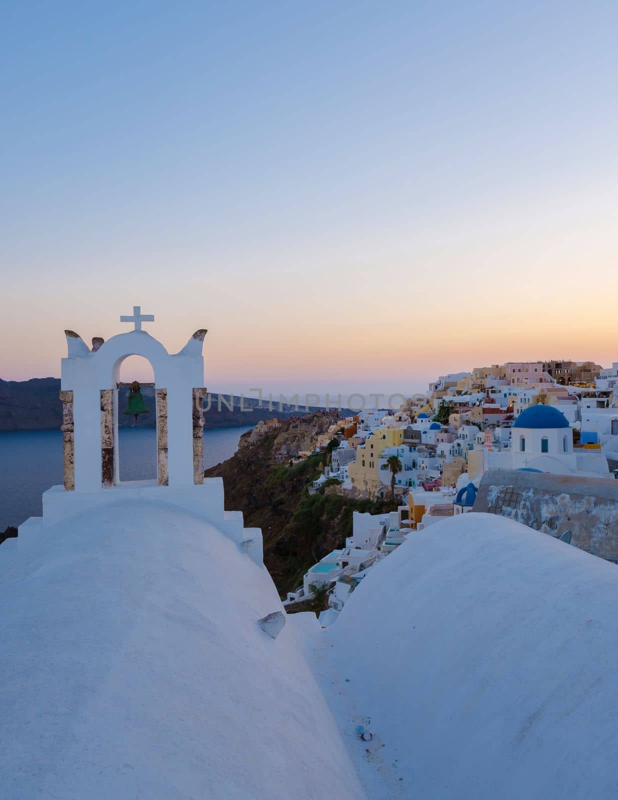 White churches an blue domes by the ocean of Oia Santorini Greece, a traditional Greek village in Santorini. 