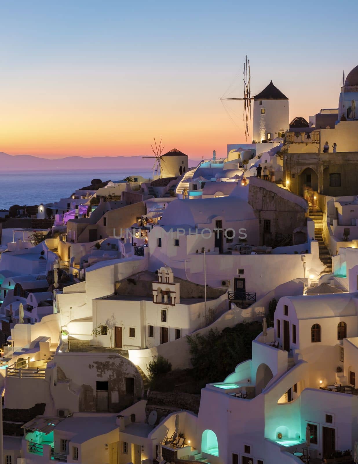 White churches an blue domes by the ocean of Oia Santorini Greece, a traditional Greek village in Santorini. 