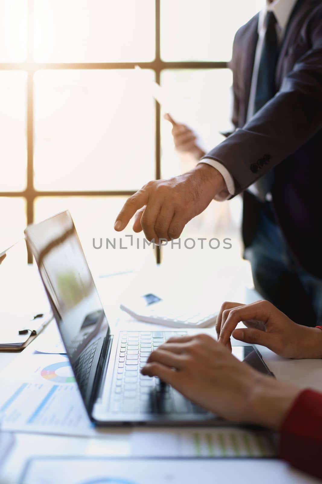 Team business adviser meeting to analyze and discuss the situation on the financial report n the meeting room with using computer laptop, documents, calculator in work