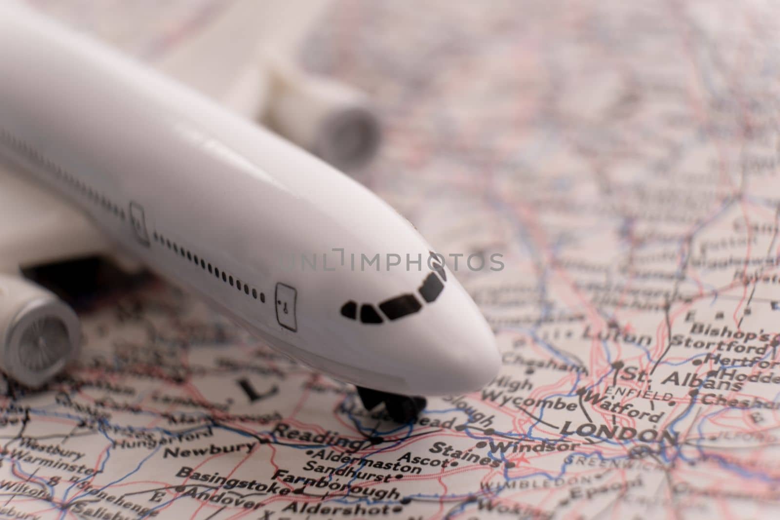 Close up of a miniature passenger plane on a colorful map highlighting Lisbon, Portugal through selective focus, background blur. High quality photo