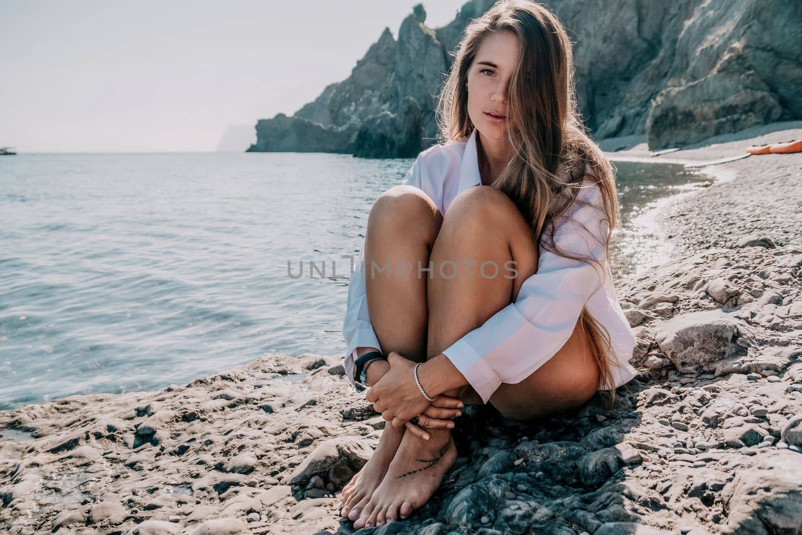 Sexy young woman in stylish bikini lying on seashore, closeup. Holiday, vacation and recreational concept.