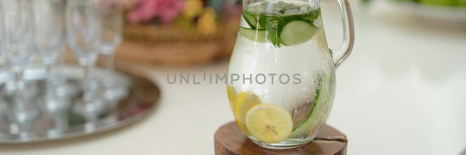 Fruit water with lemon lime cucumber and mint in glass jug by kuprevich