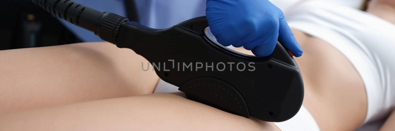 Beautician removes hair in bikini area with laser. Client in underwear for laser hair removal in bikini area