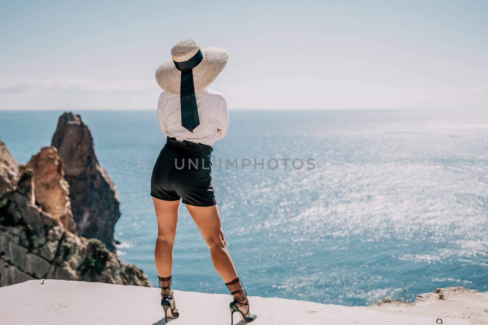 Happy girl doing yoga with laptop working at the beach. beautiful and calm business woman sitting with a laptop in a summer cafe in the lotus position meditating and relaxing. freelance girl remote work beach paradise