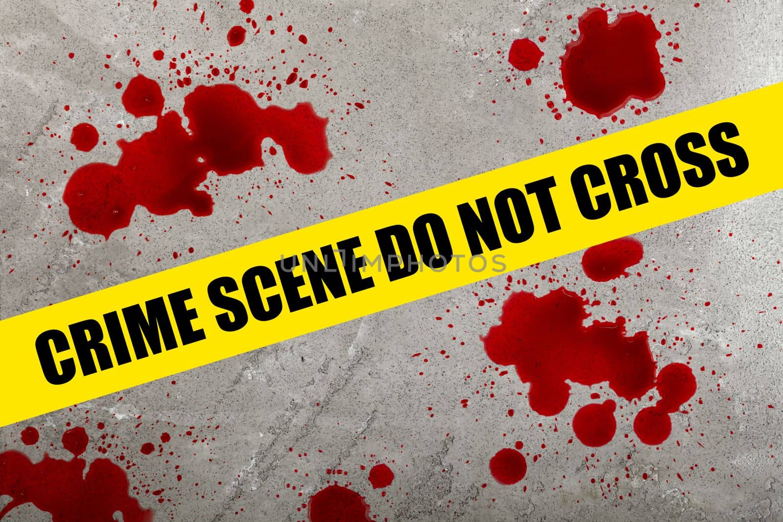 Close up yellow police barricade tape with crime scene do not cross words over blood stains splattered on grey stone floor background