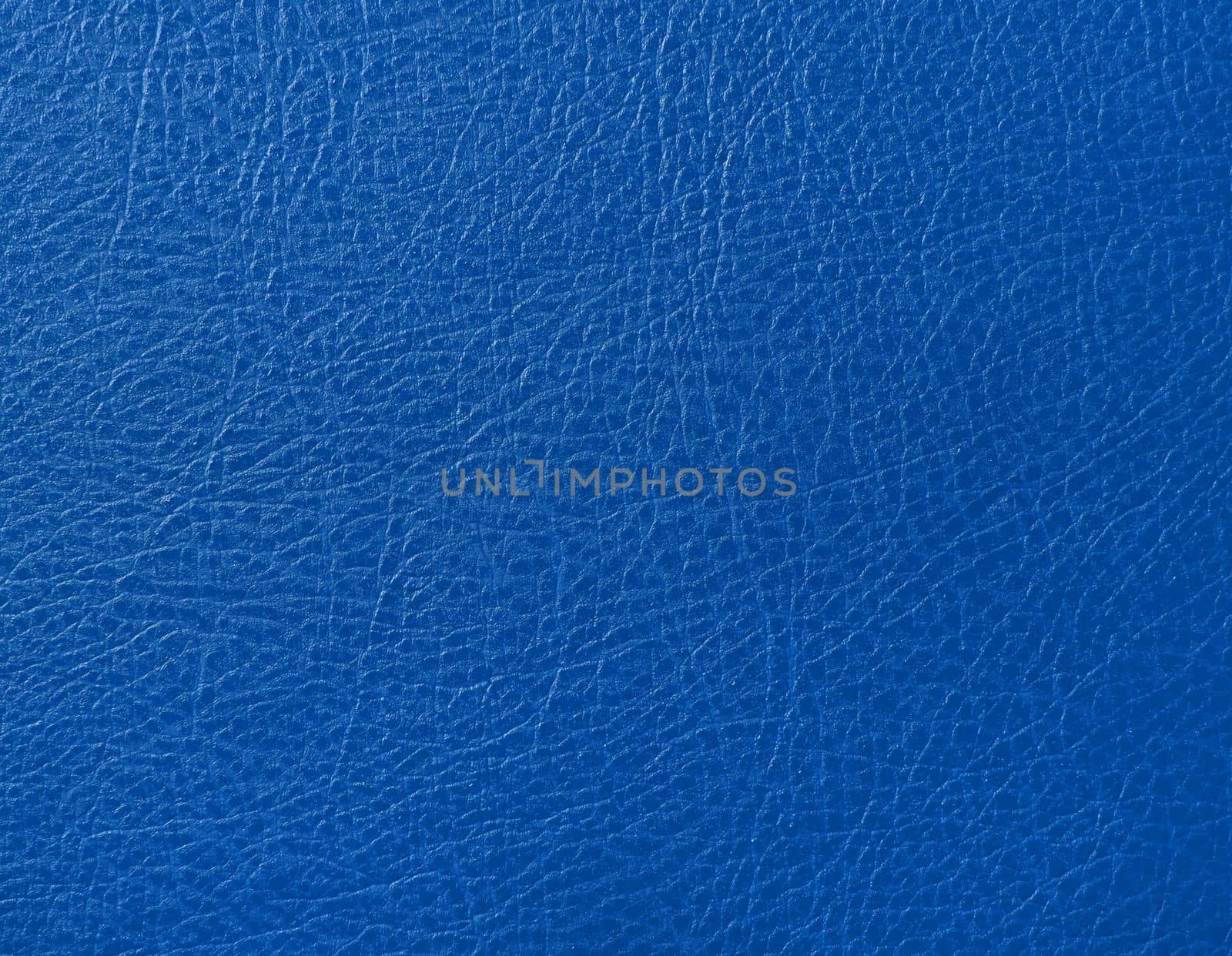 Close up background texture pattern of blue natural leather grain, directly above