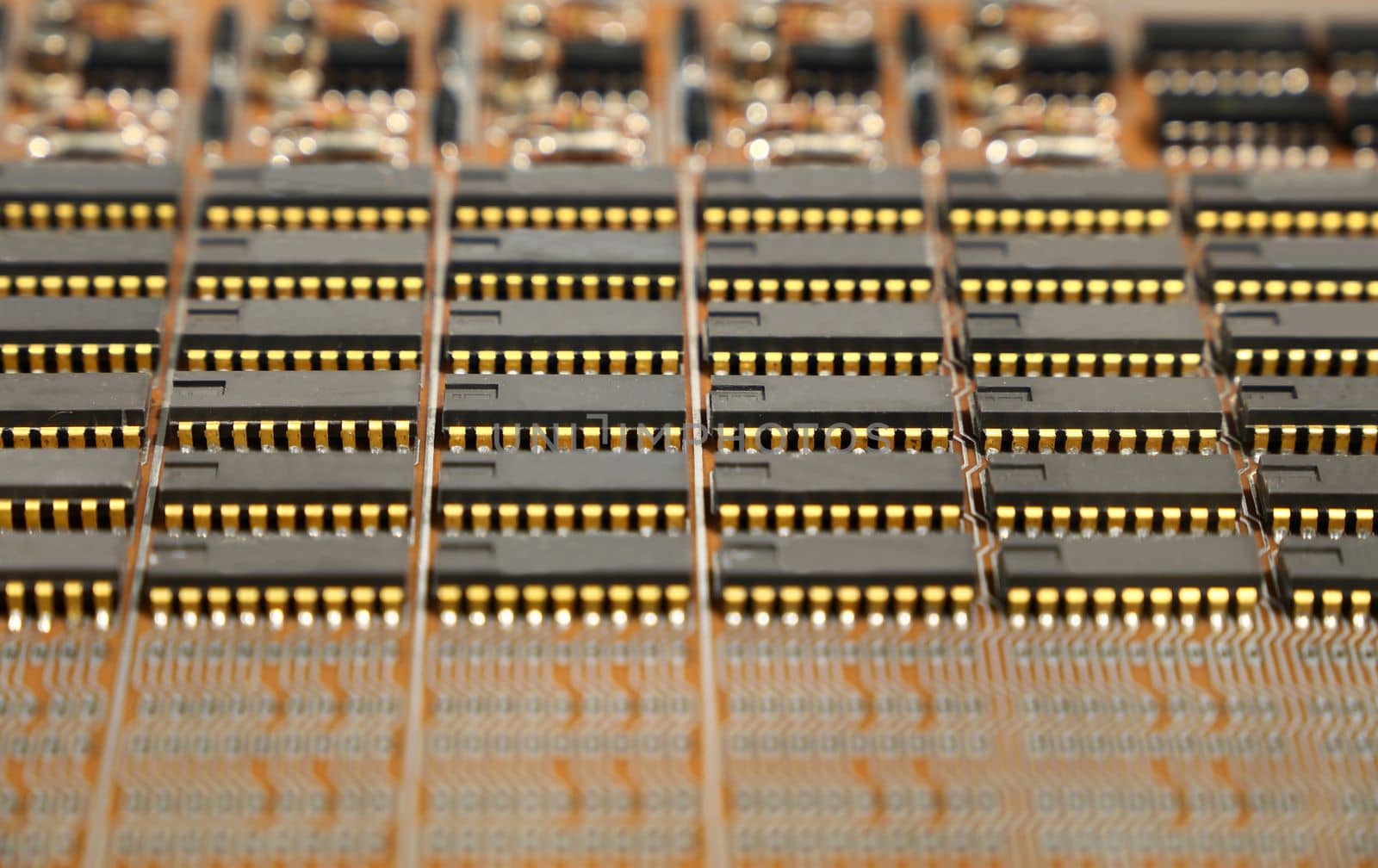Vintage electronic circuit board with microprocessors and condensers, close up, macro shot