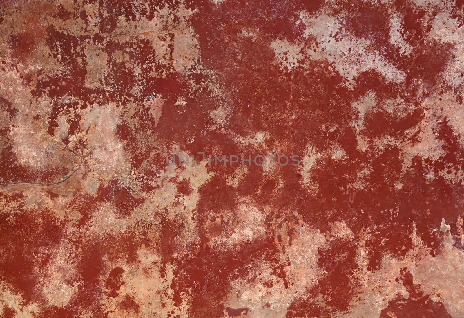 Grunge red and brown old painted concrete or stone wall background texture with stains of faded paint peel and scaling, uneven and weathered
