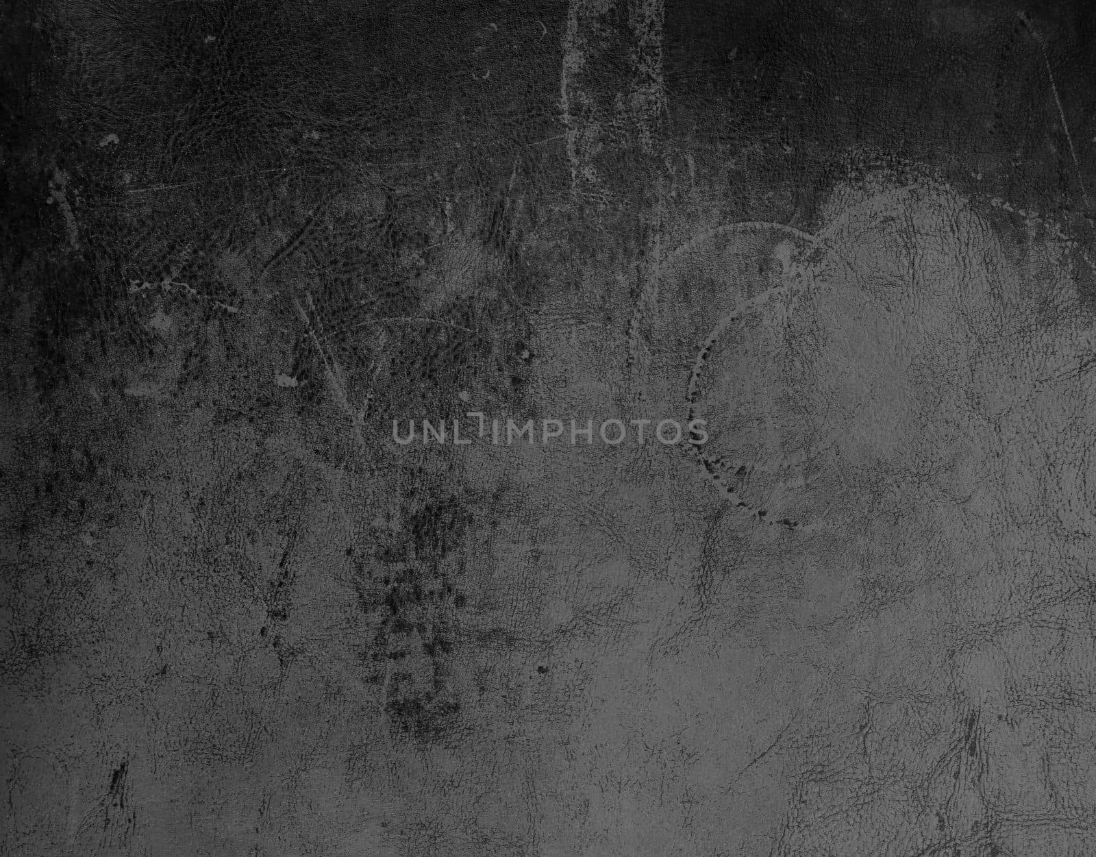 Grunge uneven abstract background of dark grey and black leather grain texture with stains and scratches