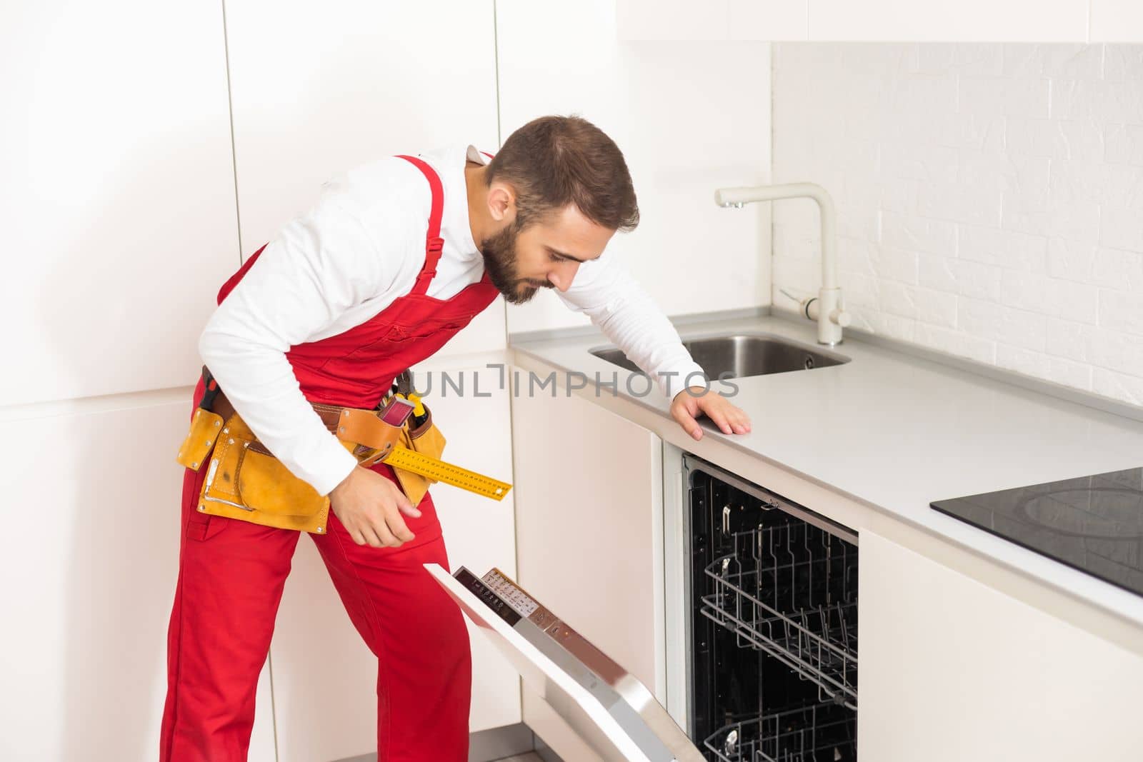 Crafts man repairs broken dishwasher by Andelov13