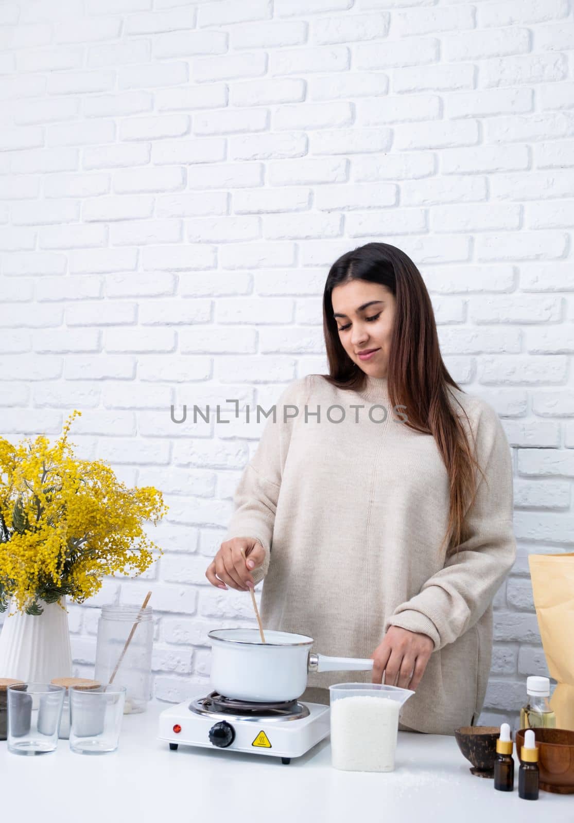 Woman making decorative aroma candle at table, closeup by Desperada